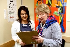 Nursing Professor Rebecca Carley speaks with student Carly Masse about a patient she examined at the RI Free Clinic.