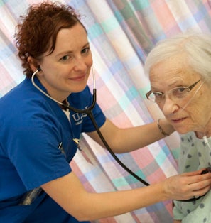 A nurse cares for an elderly woman.